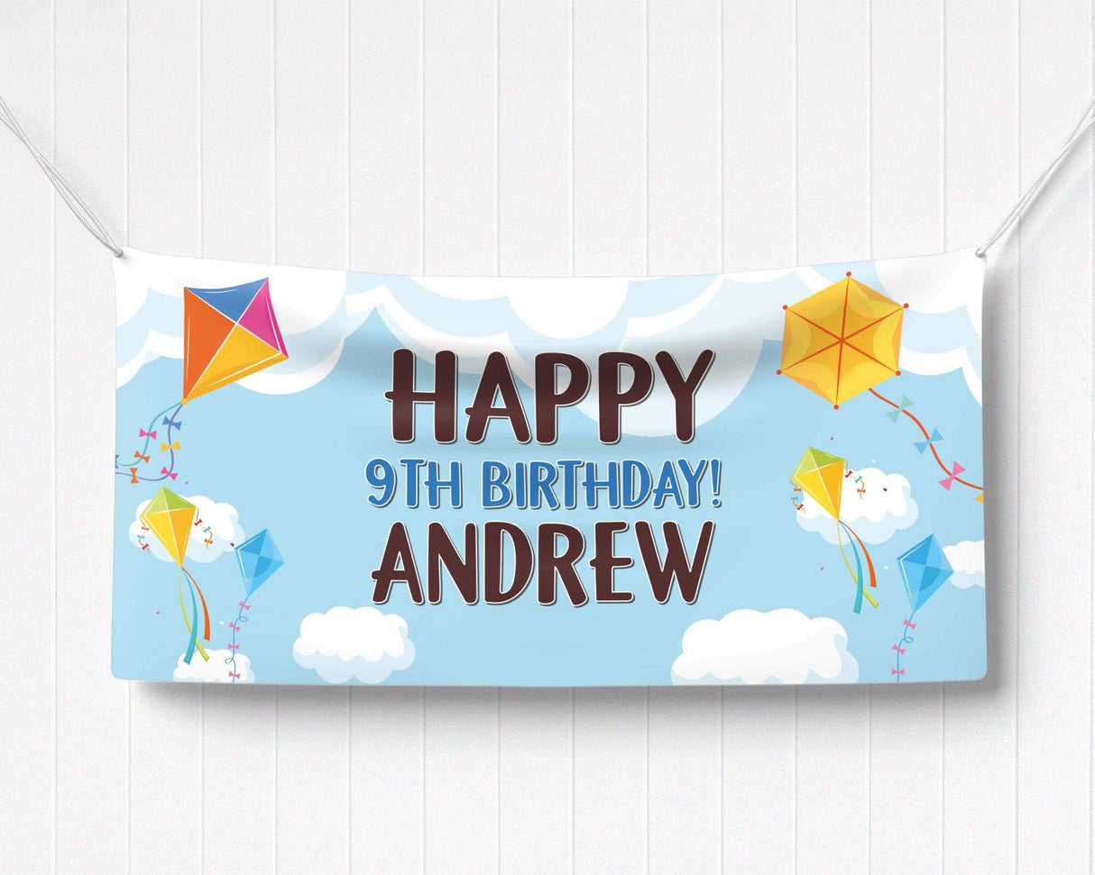 Colorful kite-themed birthday banner featuring bright kites, fluffy clouds, and playful typography on a blue sky background. Perfect for an outdoor, spring, or summer birthday party.