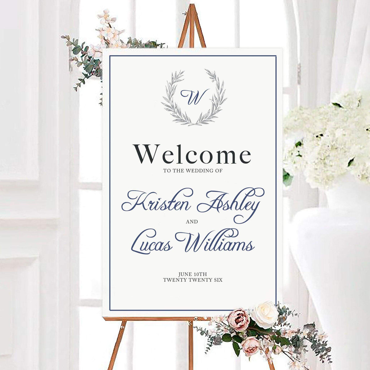 Elegant formal marriage wedding welcome sign with a personalized monogram inside a botanical laurel wreath. Classic border and script lettering display the couple’s names and wedding date.