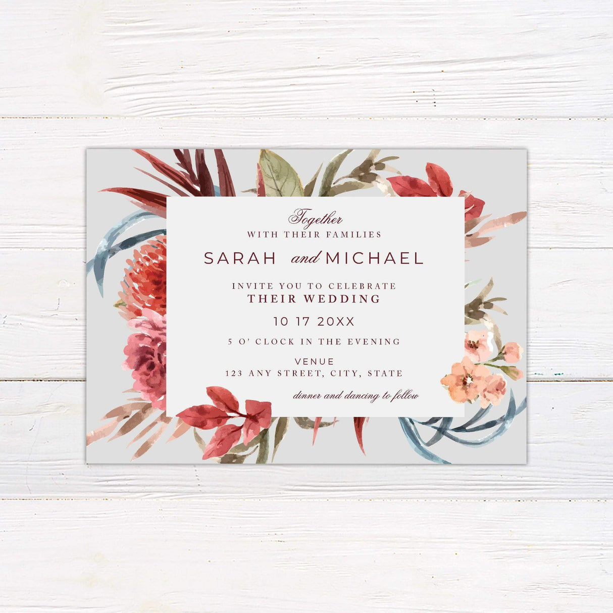 Tropical floral wedding invitation with bright pink and red watercolor flowers framing elegant wedding details on a soft mint background.