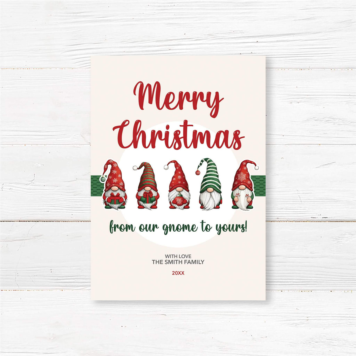 Christmas card with six festive gnomes and text reading "Merry Christmas from our gnome to yours" on a light cream background.