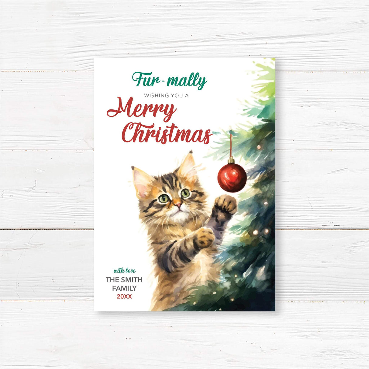 Watercolor Christmas card featuring a cute tabby cat playing with a red ornament, with text “Fur-mally Wishing You a Merry Christmas.”