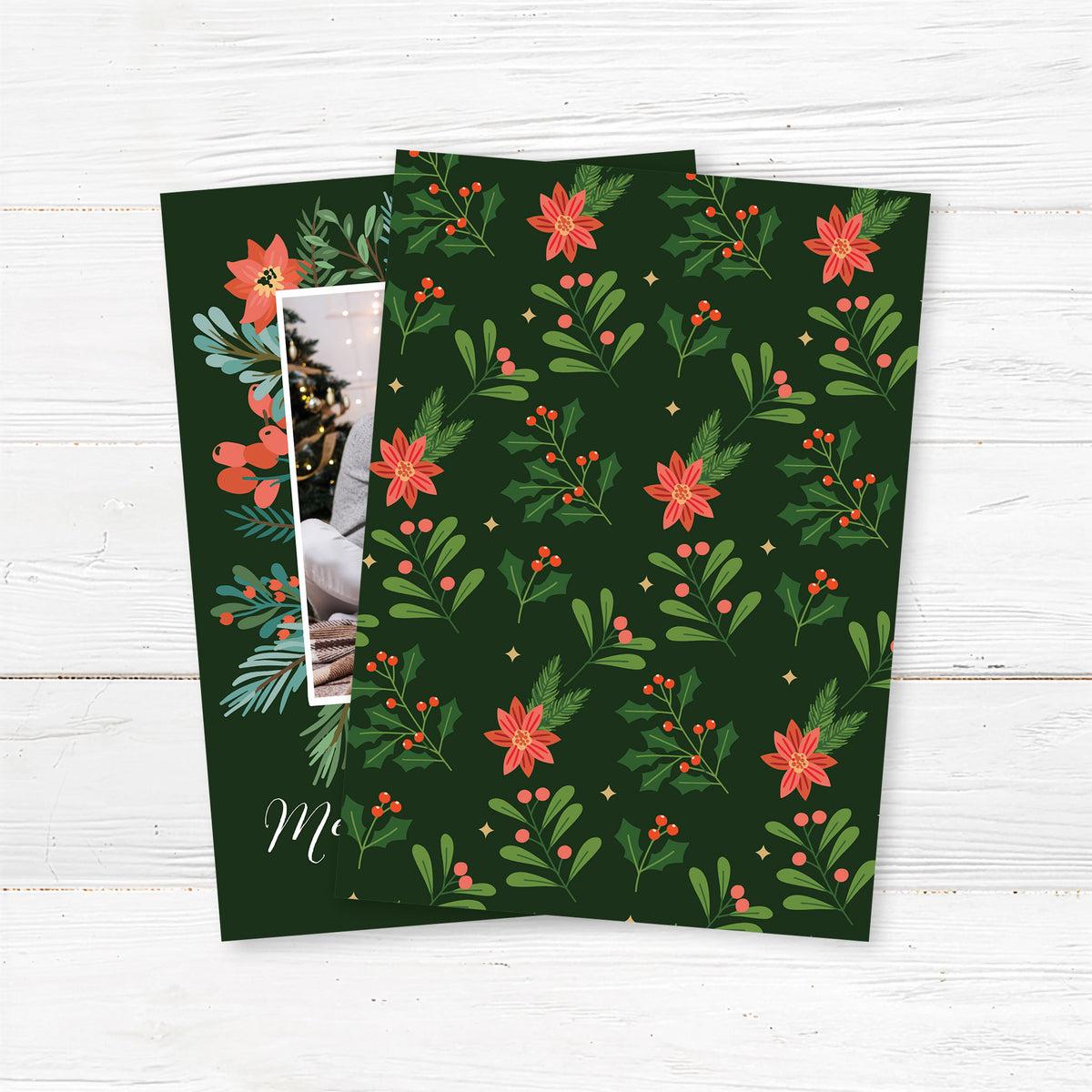 Personalized festive garland frame photo Christmas card featuring a family photograph framed by festive greenery, poinsettias, holly, and berries with elegant Merry Christmas lettering. The coordinating back features a repeating Christmas botanical pattern on a deep green background. - back.