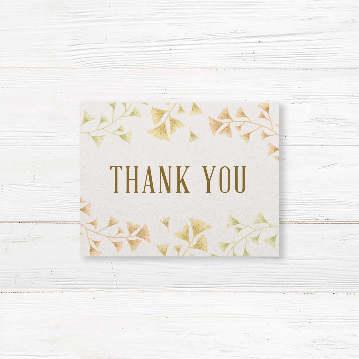 Floral wedding thank you card featuring hand-drawn ginkgo leaves and elegant typography. Printed on premium-quality cardstock with matching envelopes. Available in folded or flat formats. Perfect for expressing gratitude after weddings, bridal showers, or engagements while complementing a botanical wedding theme.