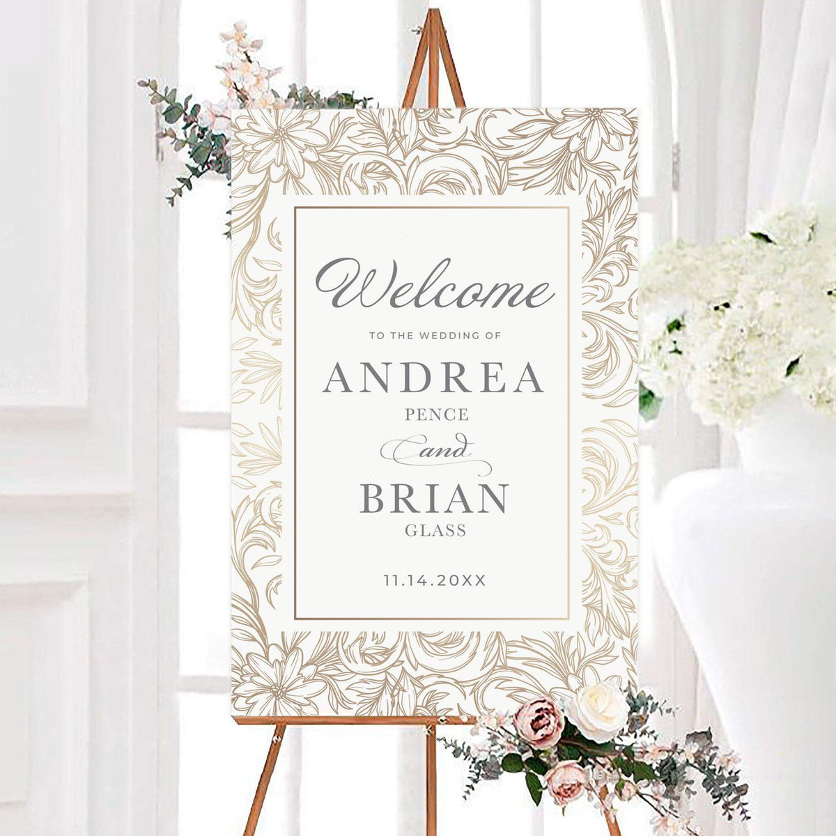 Personalized gold floral sketch wedding welcome sign featuring a detailed floral sketch border surrounding an elegant center panel. The couple’s names and wedding date are displayed in classic serif and script typography.