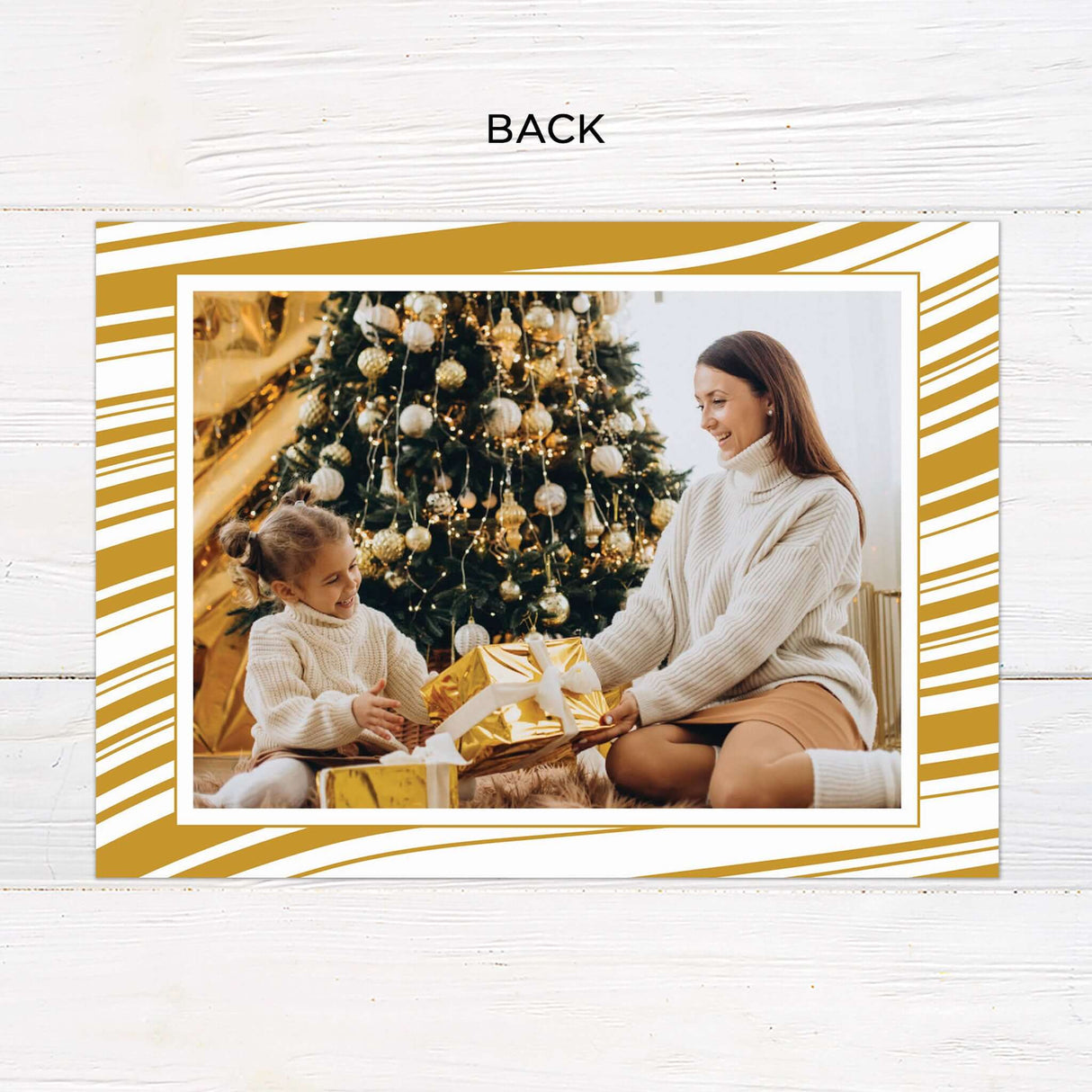 This gold minimalist gatefold Christmas card features a sleek layout with modern typography and botanical illustrations. The design includes space for a photo and a customizable holiday message. - back.