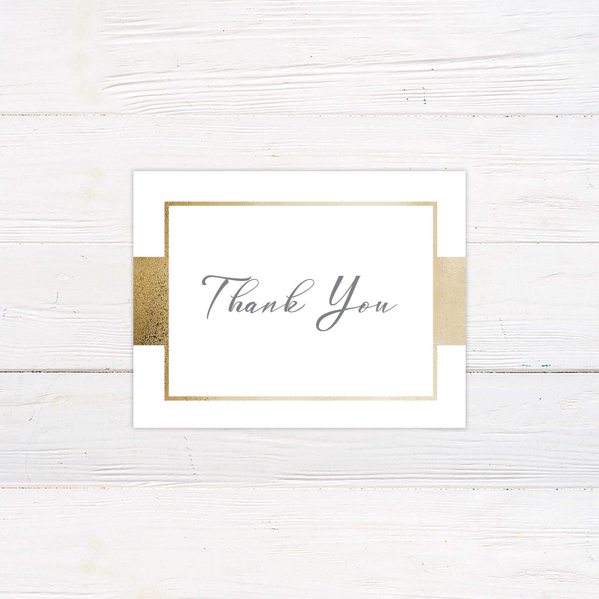 A thank you card with a white background features a modern and elegant design with a metallic gold border. The text is arranged in a refined mix of serif and script fonts, creating a sophisticated and timeless look. Event details, including the date, time, and venue, are centered for a structured and polished appearance. This design exudes luxury and simplicity, making it perfect for formal, modern, or classic wedding celebrations.