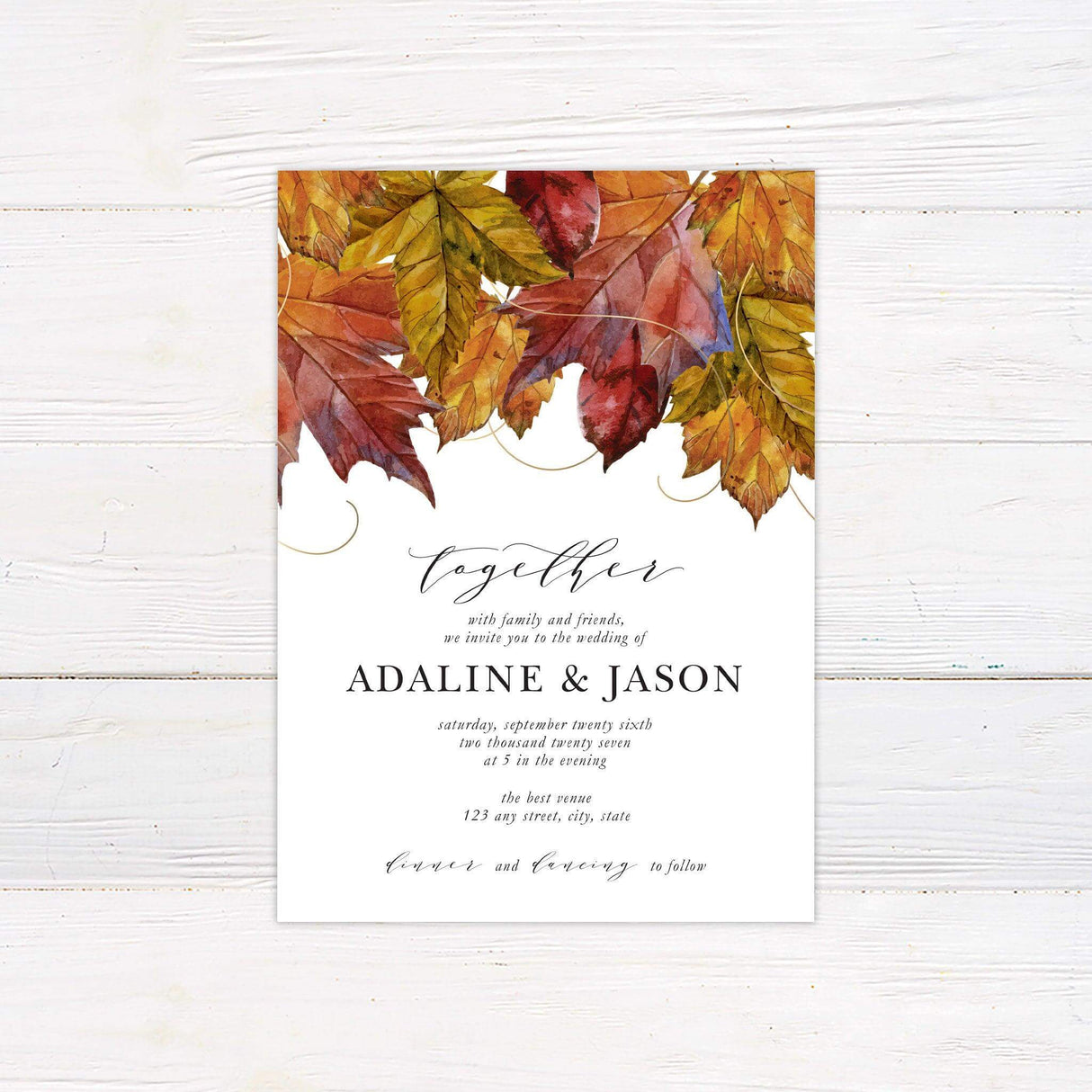 Autumn wedding invitation featuring watercolor red, orange, and gold leaves with elegant calligraphy and serif typography