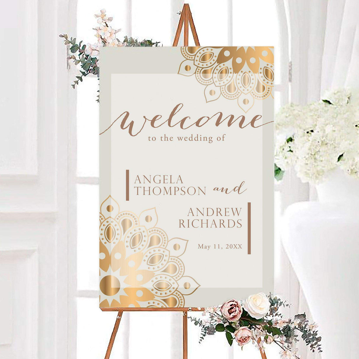 Elegant golden mandala wedding welcome sign featuring decorative gold mandala patterns, neutral tones, and sophisticated script and serif lettering. The sign is personalized with the couple’s names and wedding date.