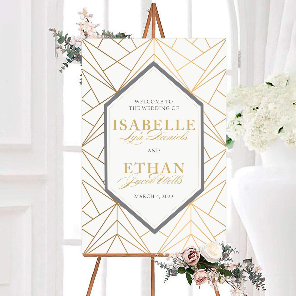 Personalized golden web wedding welcome sign featuring geometric line work and an angular center frame. The couple’s names and wedding date are displayed with elegant serif and script typography.