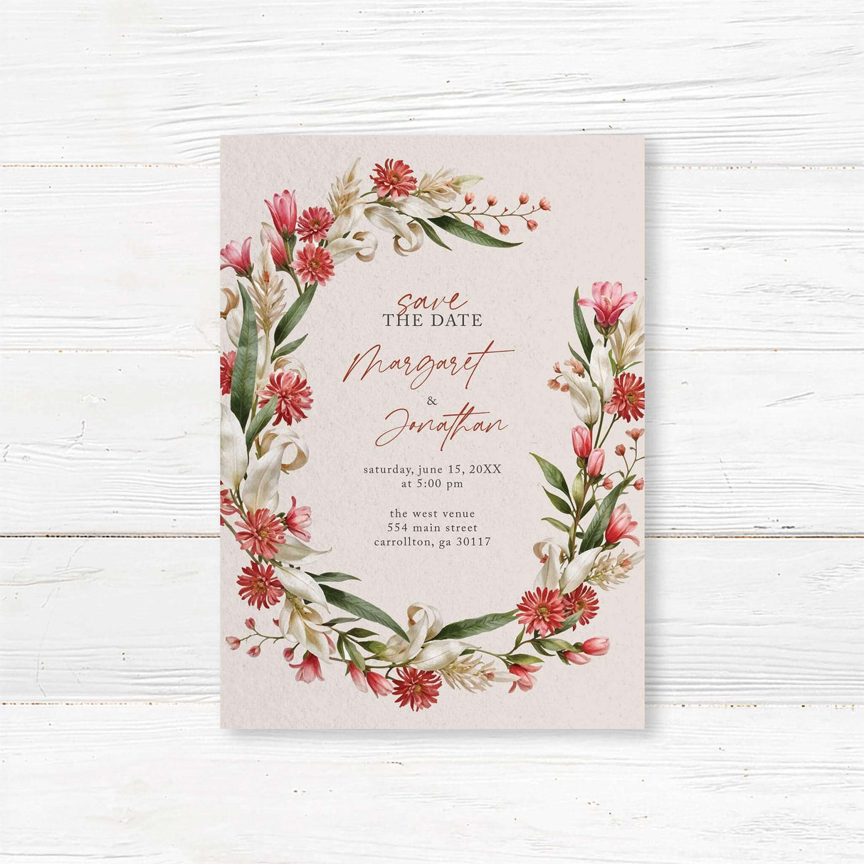 Elegant save the date with a floral design featuring red, pink, and white flowers with green leaves arranged in a wreath. The text is in a mix of script and serif fonts on a cream-colored background, providing event details such as the couple's names, date, time, and location.