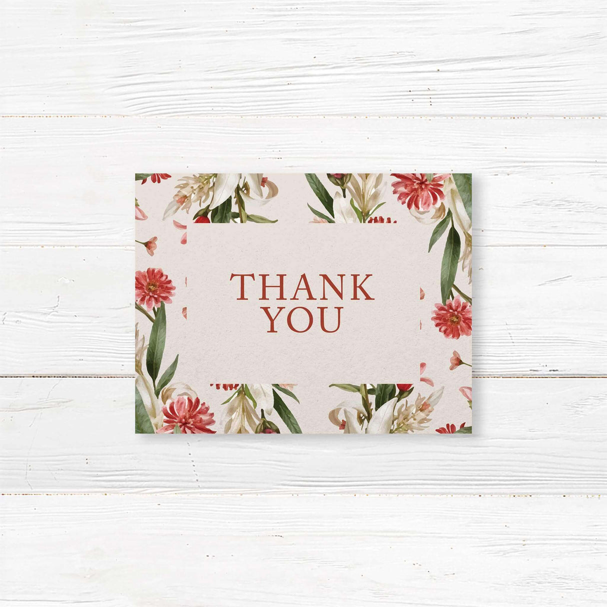 Elegant note card with a floral design featuring red, pink, and white flowers with green leaves arranged in a wreath. The text is in a mix of script and serif fonts.