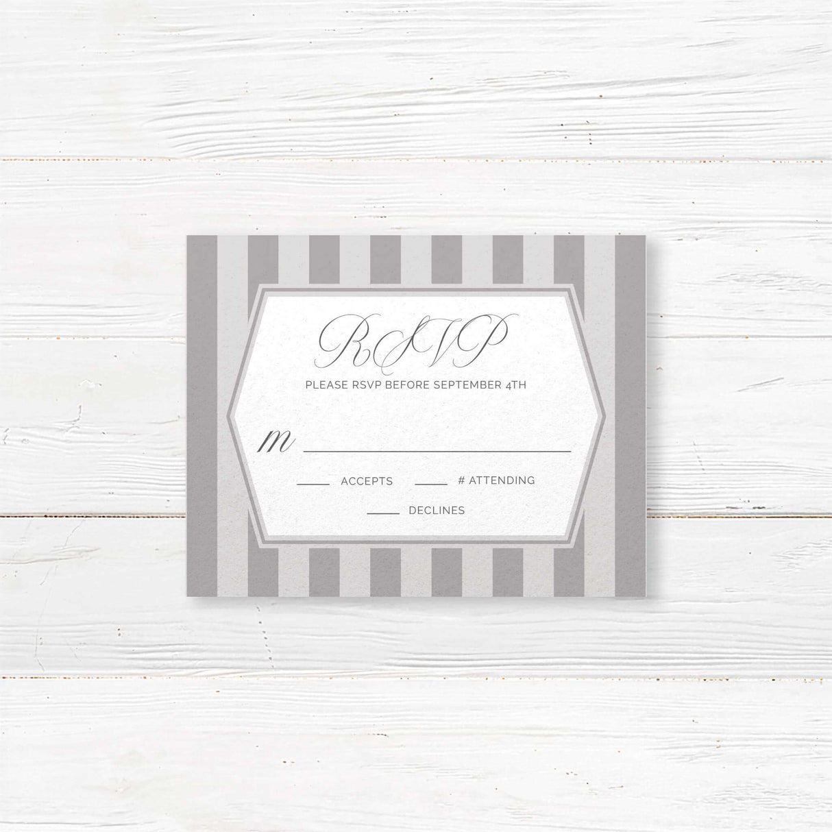 Gray and white RSVP card with vertical stripe accents and monogram crest