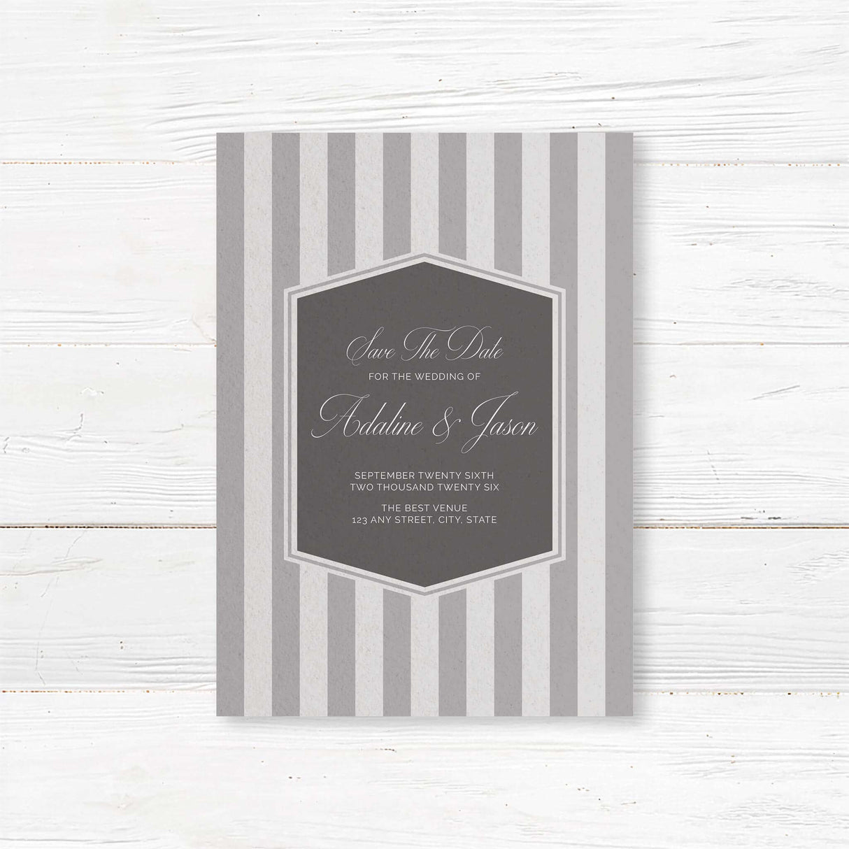 Save the Date card with gray stripes, monogram crest, and elegant serif script fonts