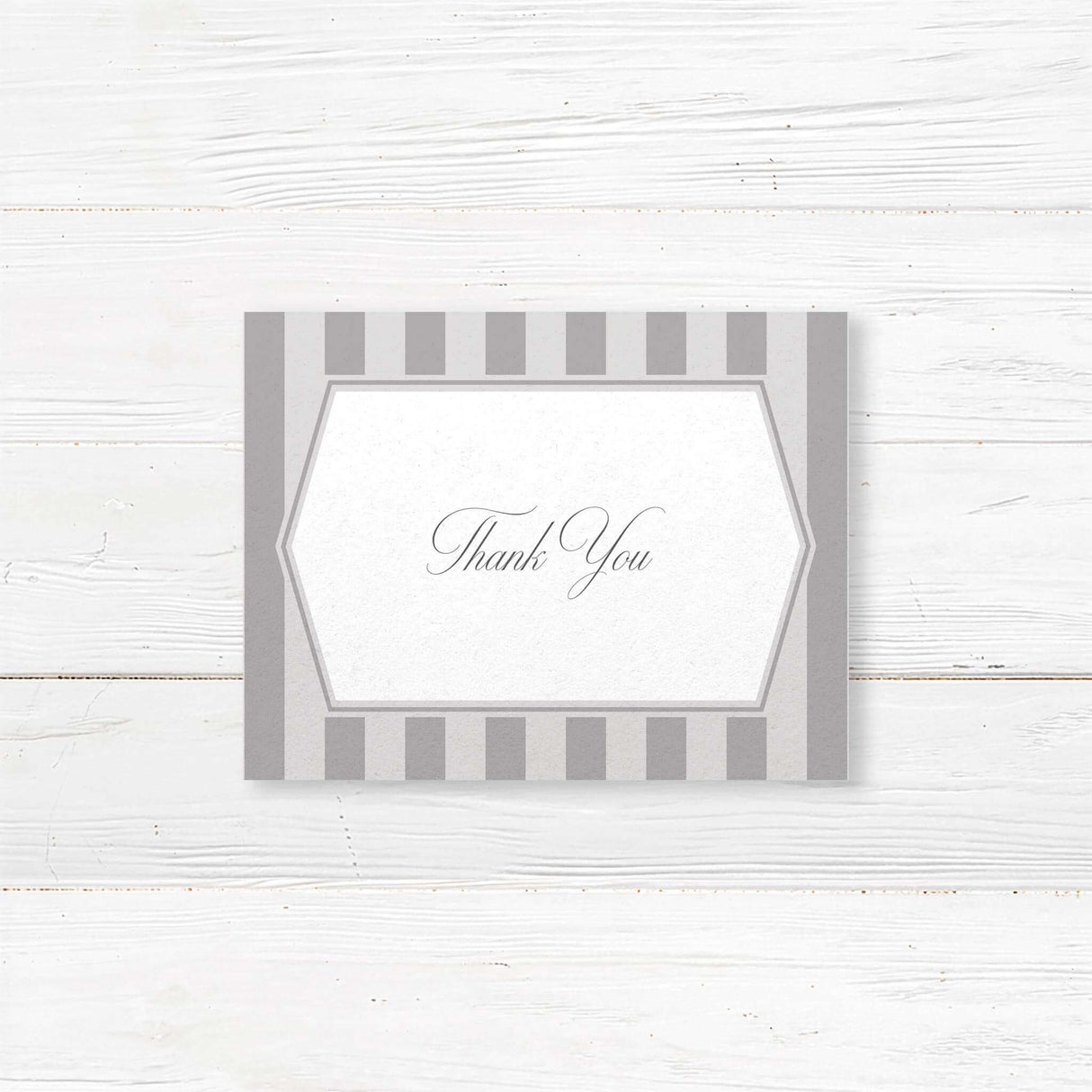 Gray thank you card with vertical stripes, white panel, and monogram crest
