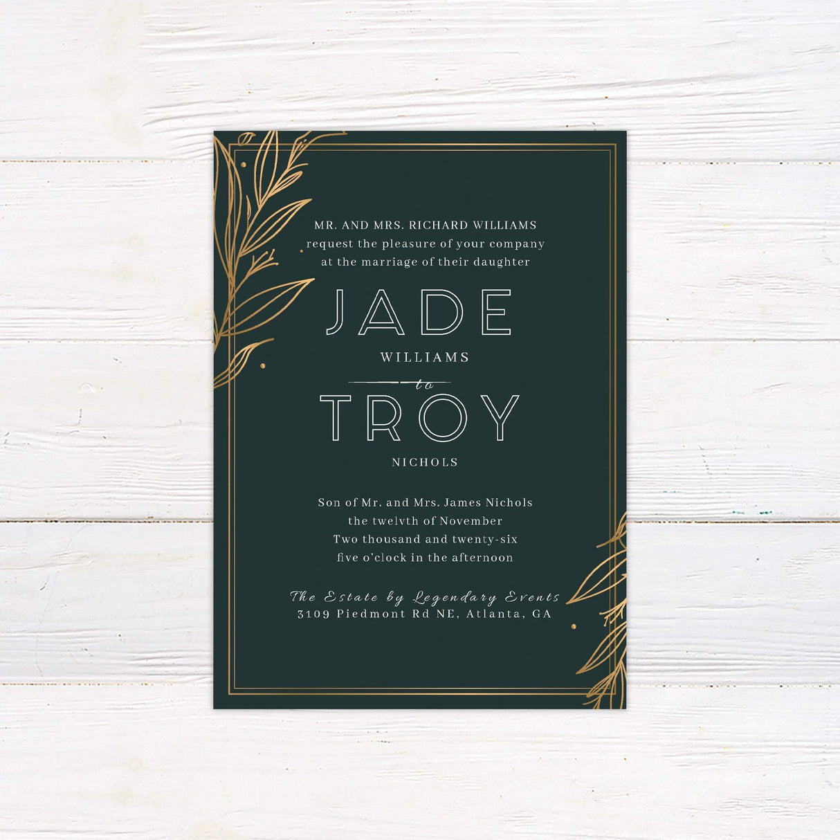 Elegant dark green wedding invitation with gold botanical leaf corner accents and modern white typography, perfect for fall or formal celebrations