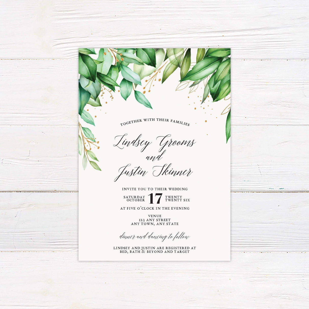Elegant greenery and gold wedding invitation with watercolor leaves and calligraphy text on white background