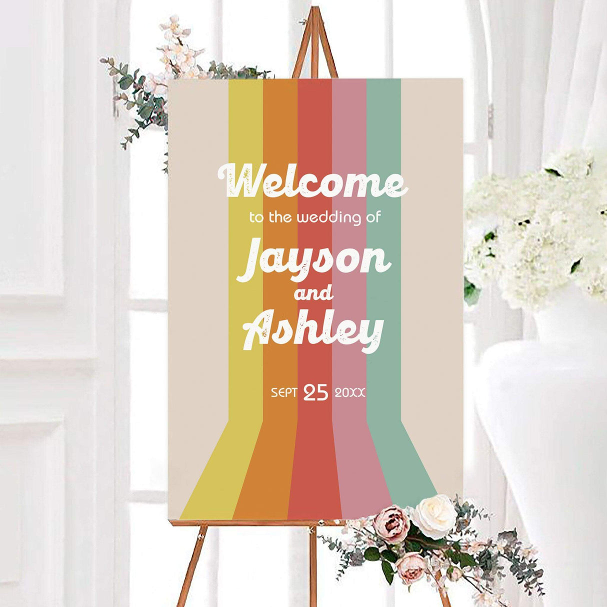 Groovy stripe wedding welcome sign with vertical mustard, orange, coral, pink, and mint green retro stripes. White vintage lettering displays the couple’s names and wedding date.