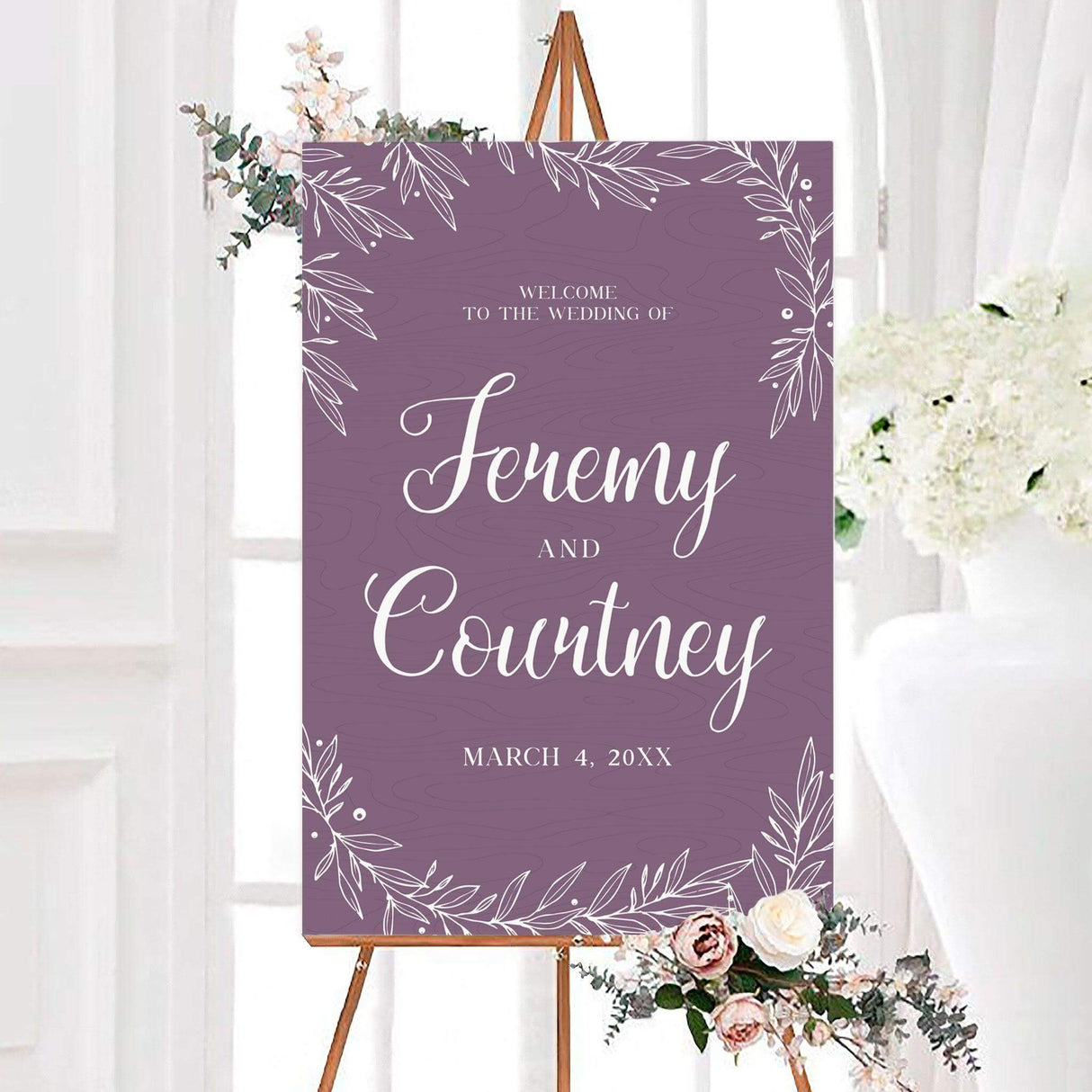 Dusty purple hand drawn wreath wedding welcome sign with white hand-drawn leafy branches, subtle woodgrain texture, and elegant calligraphy. The personalized design features the couple’s names and wedding date.