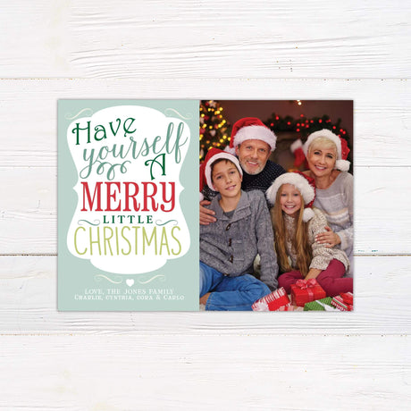 Have Yourself a Merry Little Christmas card with bold holiday typography in red, green, and gold alongside a personalized family photo.