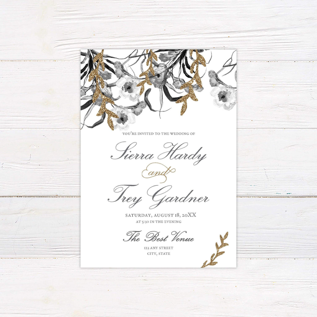 Elegant gold and gray floral watercolor wedding invitation featuring glitter accents and delicate flower designs, customizable with names, date, and venue