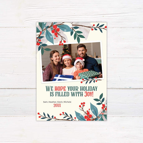 Holiday Floral Christmas photo card with red berries and winter foliage framing a family photo and the message "We hope your holiday is filled with joy!"