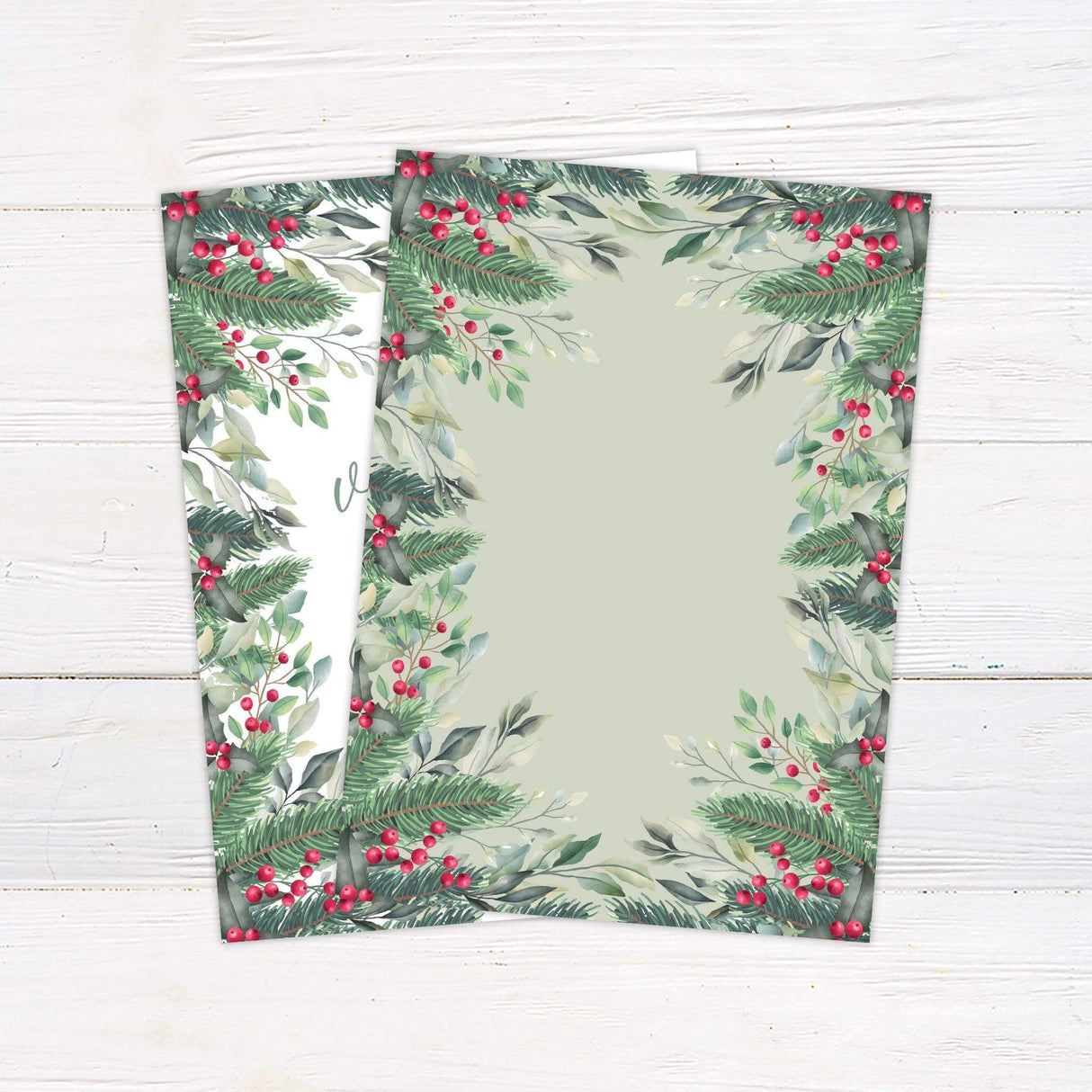 Winter wedding invitation with watercolor holly berries, pine greenery, and elegant script on a white background. - back