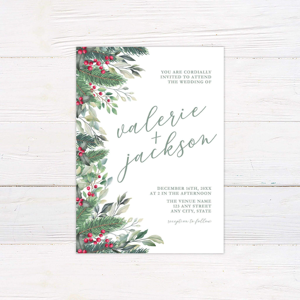 Winter wedding invitation with watercolor holly berries, pine greenery, and elegant script on a white background.
