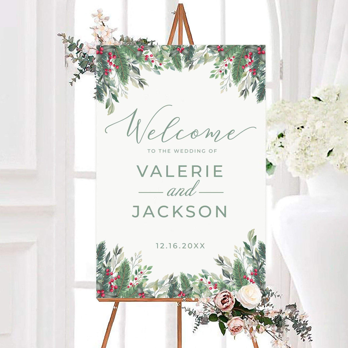 Holly berries wedding welcome sign featuring watercolor evergreen branches, holly leaves, and bright red berries framing the design. The personalized sign displays the couple's names and wedding date in soft sage green typography.