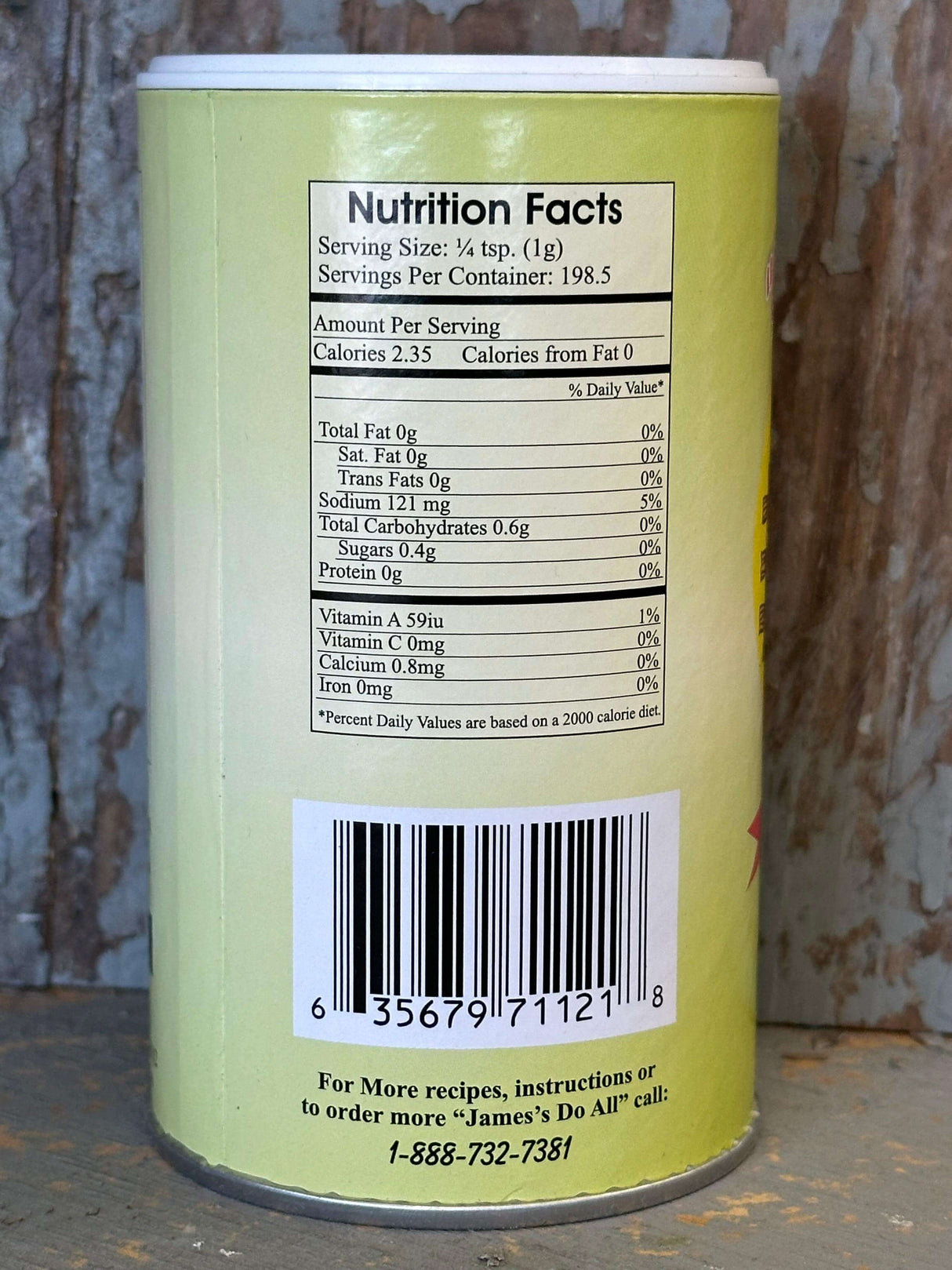 James Do All Southern Way Gourmet Seasoning canister showing nutrition facts and barcode on a rustic wood surface.
