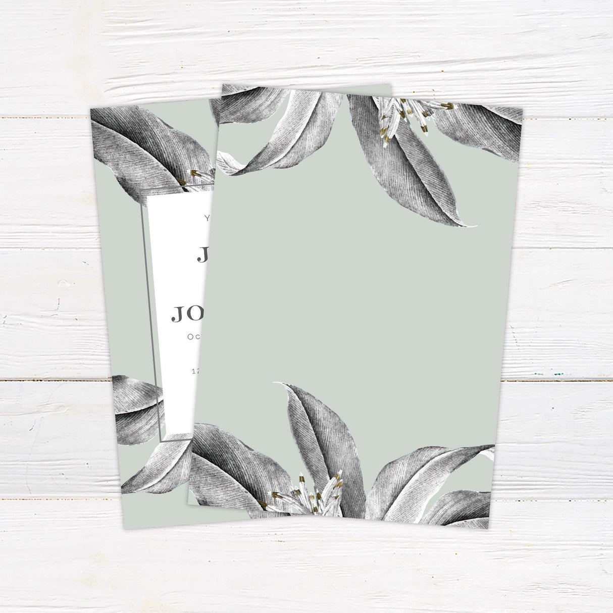 Minimalist tropical wedding invitation with green foliage and modern botanical border design. back