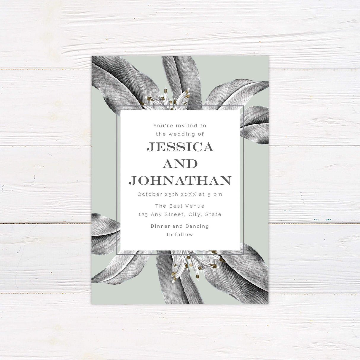 Minimalist tropical wedding invitation with green foliage and modern botanical border design.