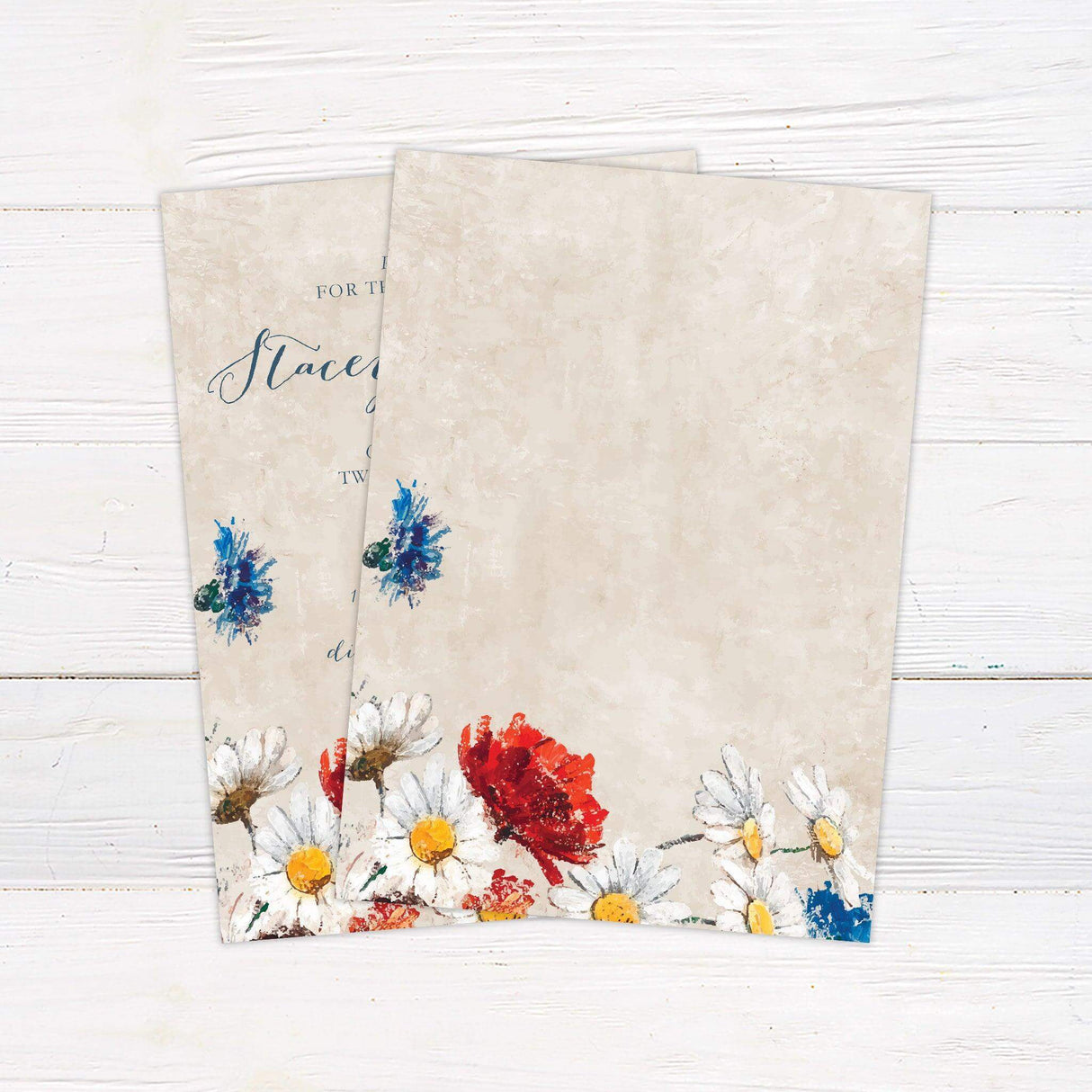 Impressionist-style wedding invitation with hand-painted wildflowers and elegant script on a rustic textured background. back
