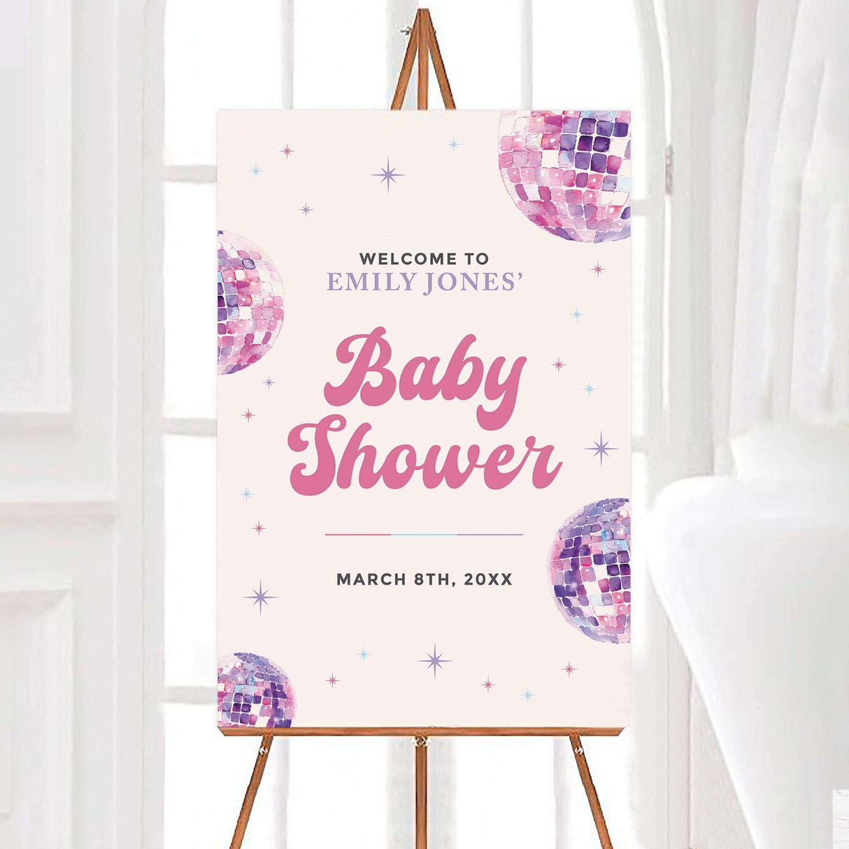 Baby shower sign with soft pastels and disco ball design, welcoming guests to the event on March 8th on an easel.