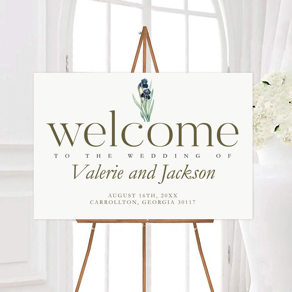 Vintage iris wedding welcome sign featuring a blue watercolor iris, elegant olive typography, and a clean white background. The personalized design displays the couple’s names, wedding date, and location.