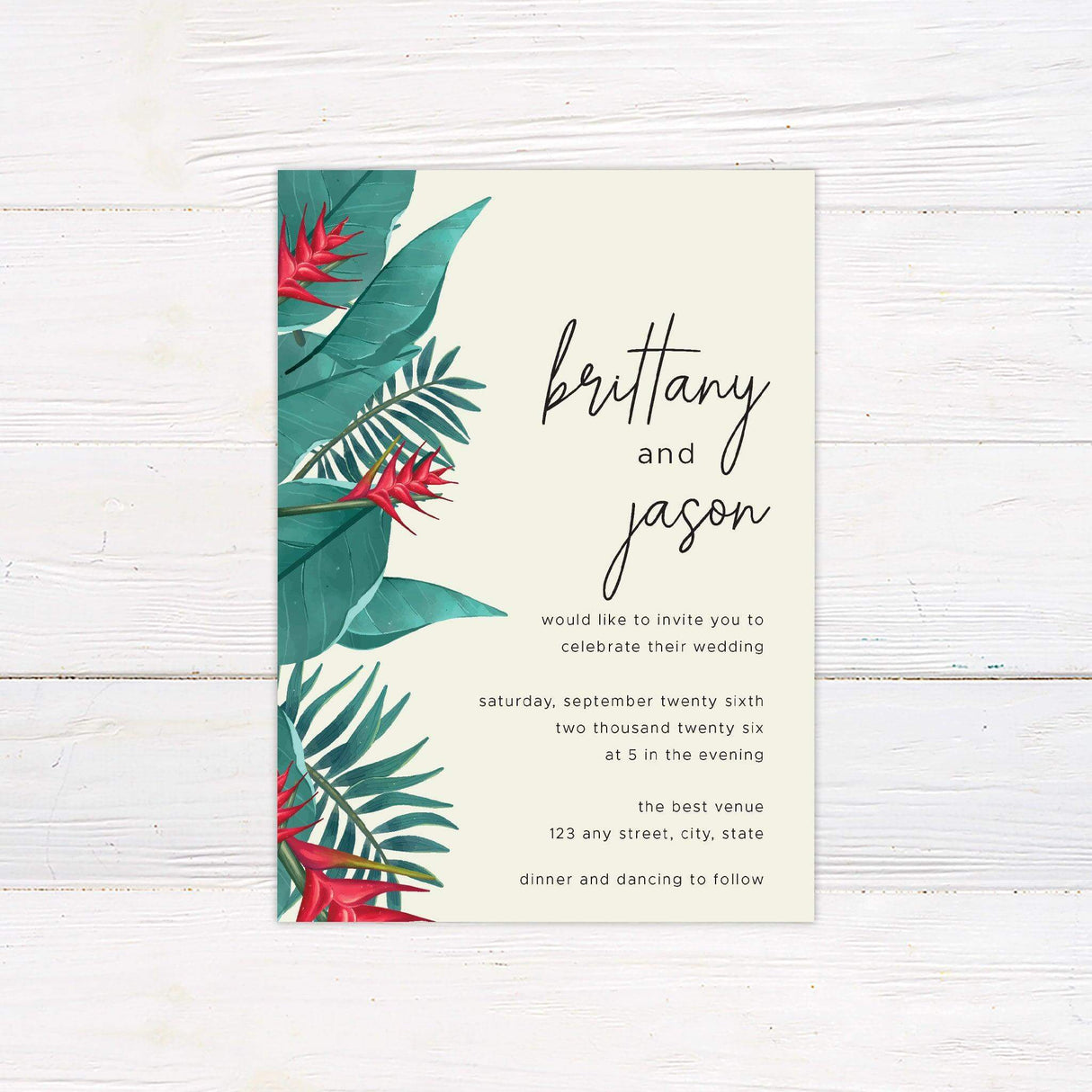 Tropical wedding invitation with green palm leaves, red tropical flowers, and elegant script text on a light pastel background