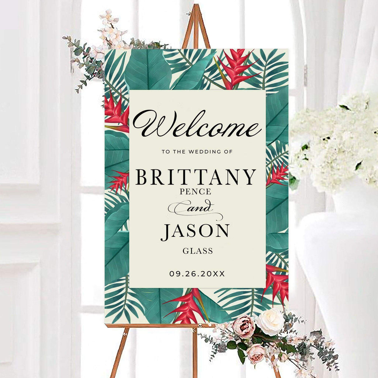 Island leaves wedding welcome sign featuring lush tropical leaves and vibrant red bird of paradise flowers surrounding personalized wedding details. The bold botanical design creates an elegant island-inspired greeting for wedding guests.