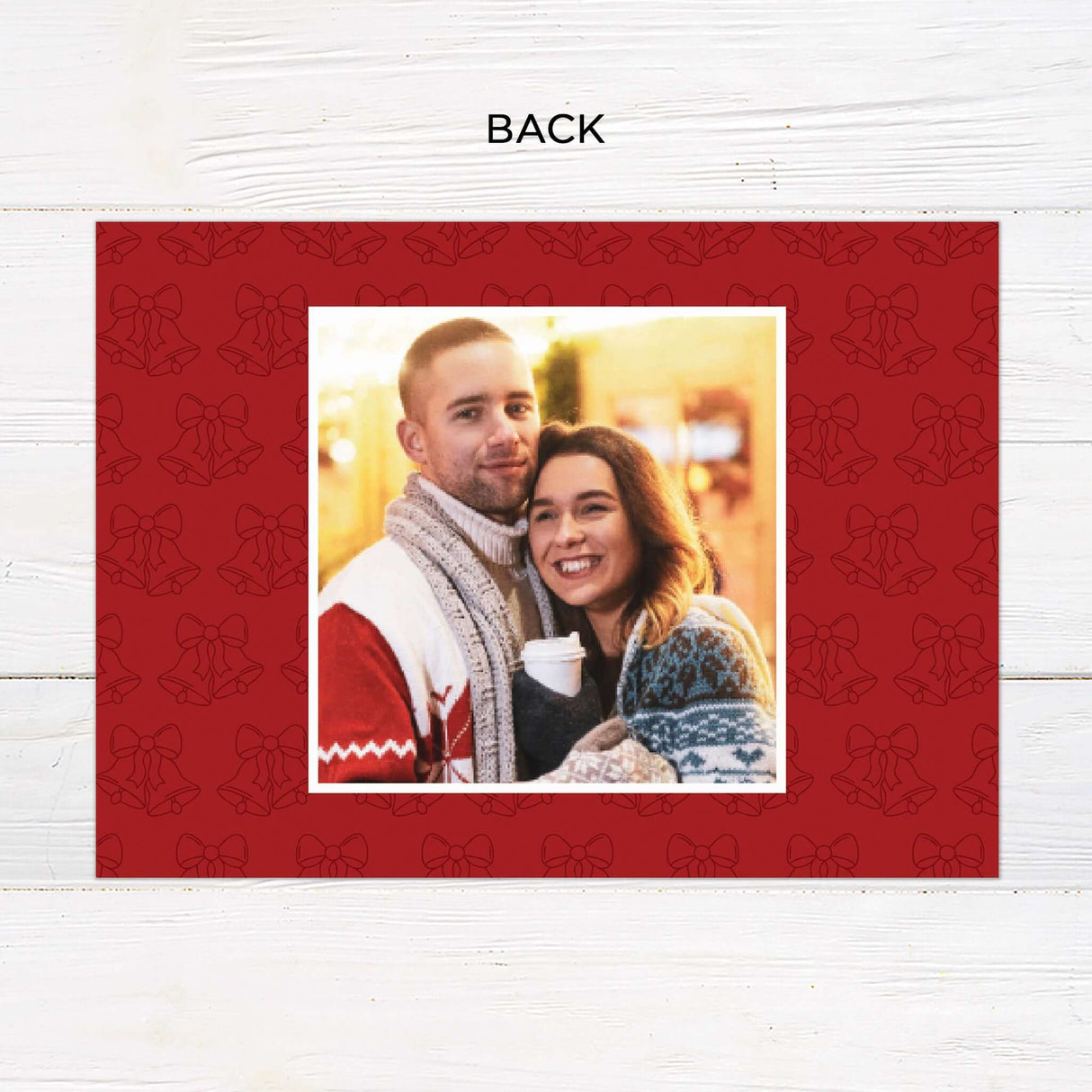 This festive gatefold holiday card features a cozy couple’s winter photo shoot with cheerful red and white backgrounds. Elegant bell illustrations, playful script fonts, and space for custom greetings make it a modern and personal way to send holiday wishes. - back.