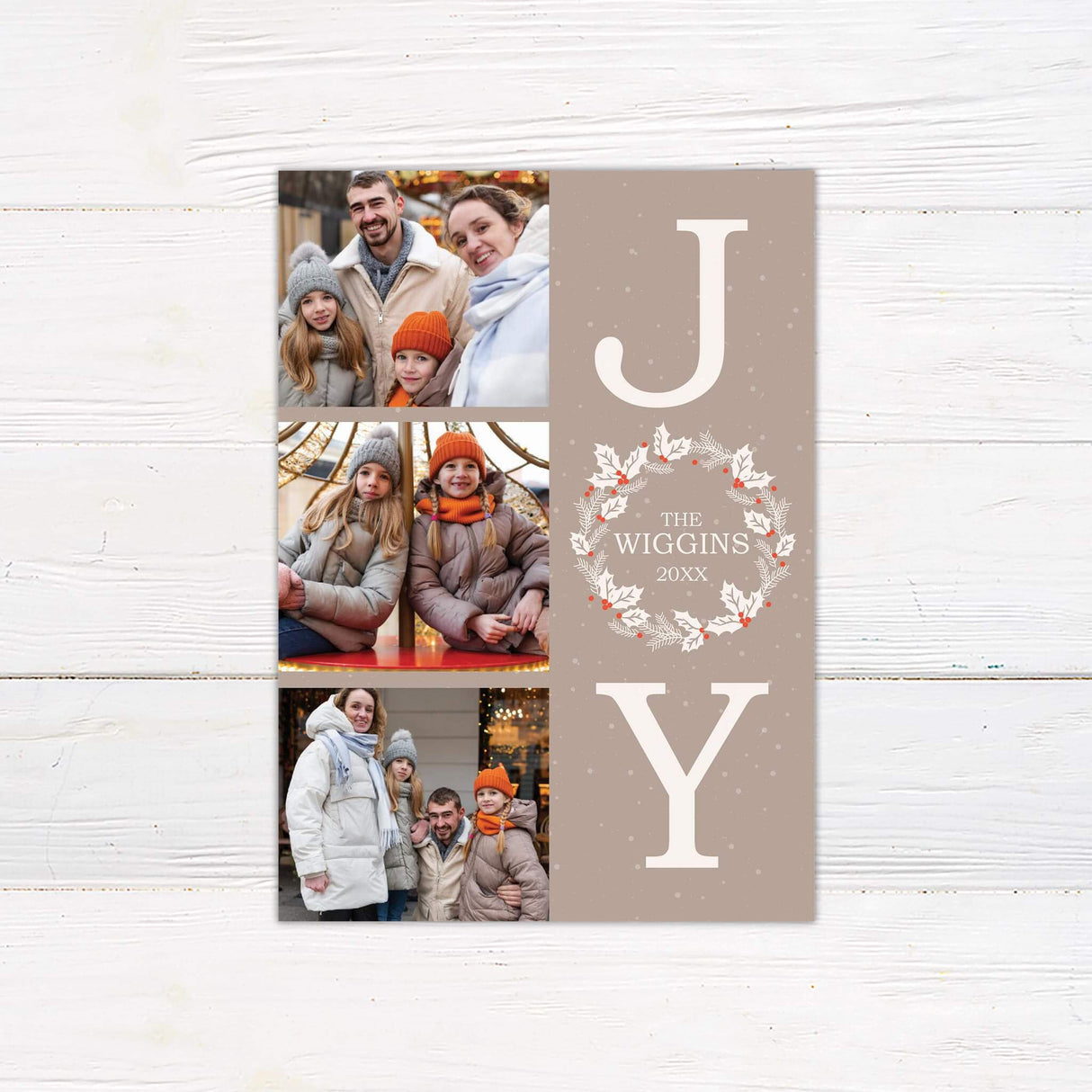 Customizable Joy Holiday Card featuring three photo slots alongside bold JOY lettering, with a festive holiday wreath as the “O” and a taupe snowflake background.