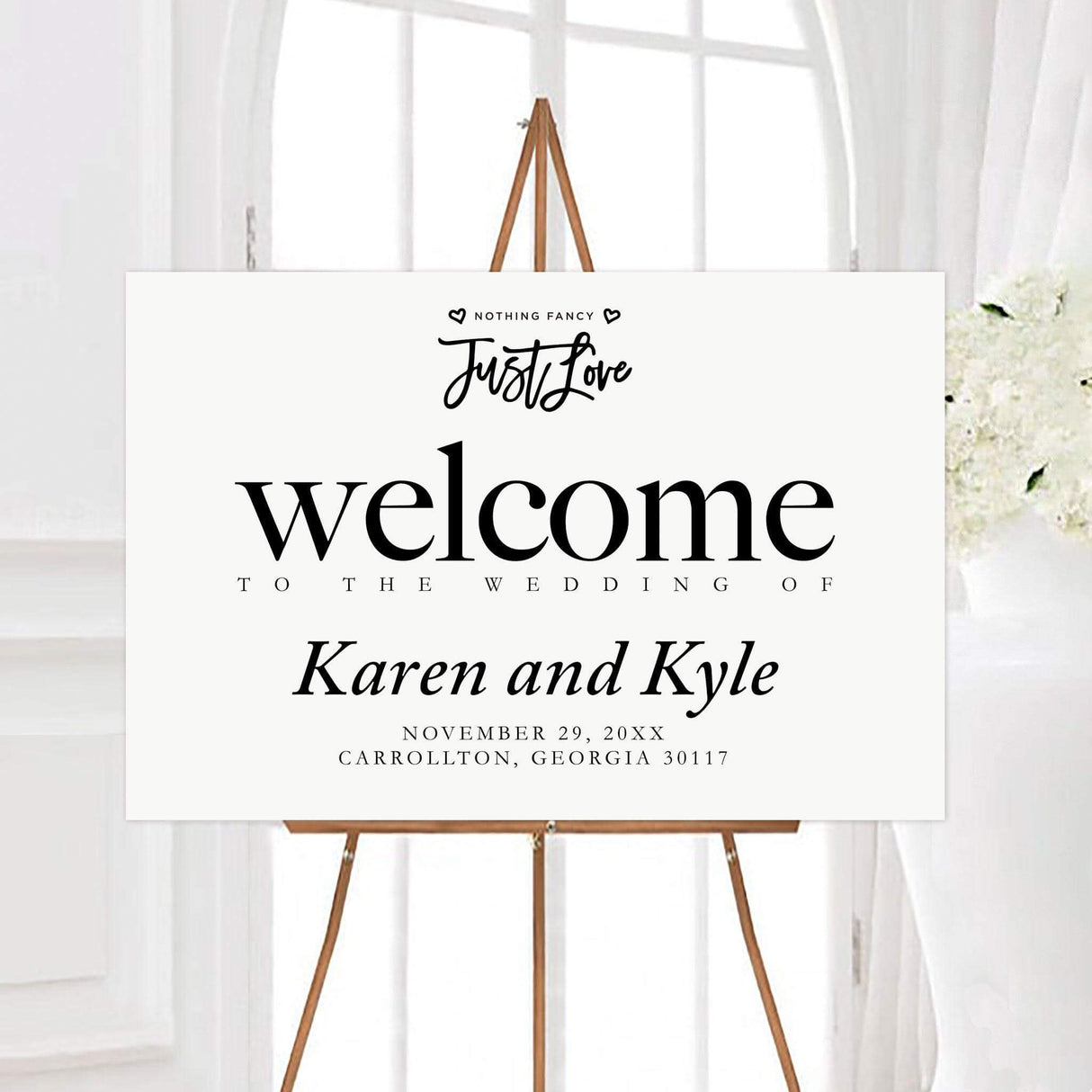 Just love black and white wedding welcome sign featuring the phrase “Nothing Fancy, Just Love,” small hearts, and personalized wedding details. The simple minimalist design creates a casual and heartfelt greeting for wedding guests.
