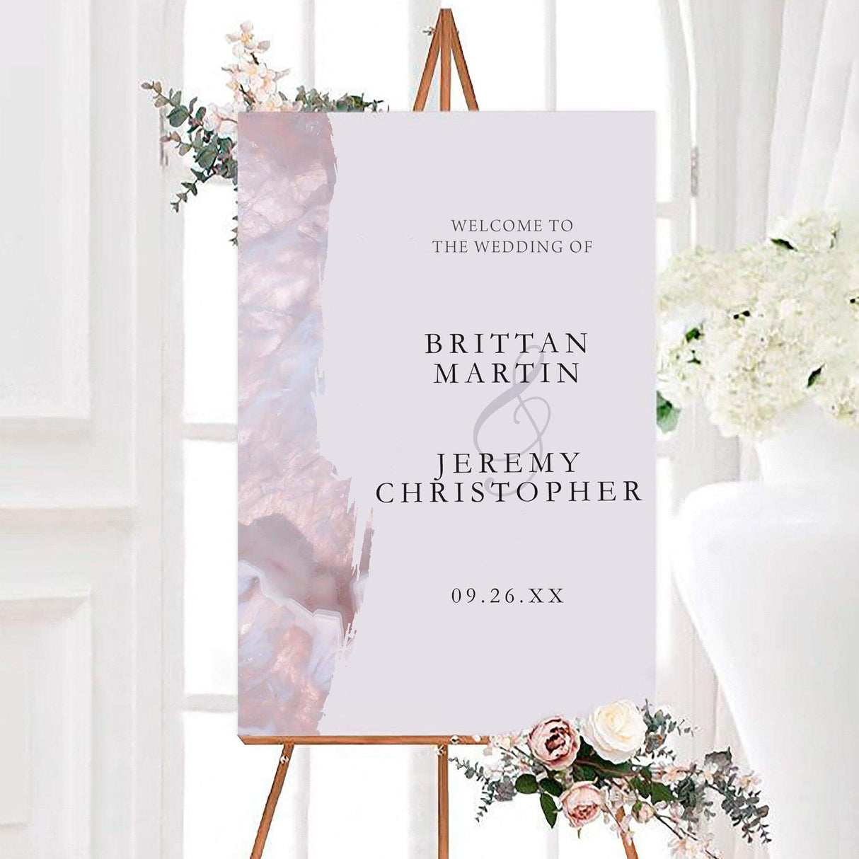 Lavender geode wedding welcome sign with soft blush crystal artwork and elegant black serif typography. The personalized design features the couple’s names, a script ampersand, and wedding date.