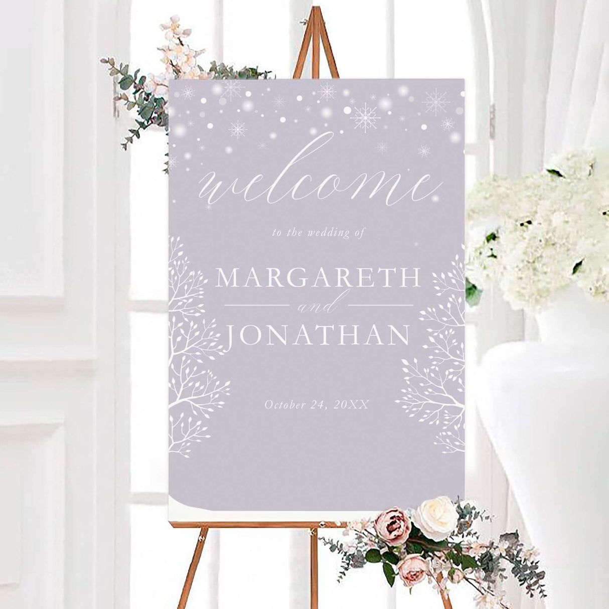 Lavender winter wedding welcome sign featuring white snowflakes, delicate botanical branches, and elegant white lettering. The personalized design displays the couple’s names and wedding date on a soft lavender background.