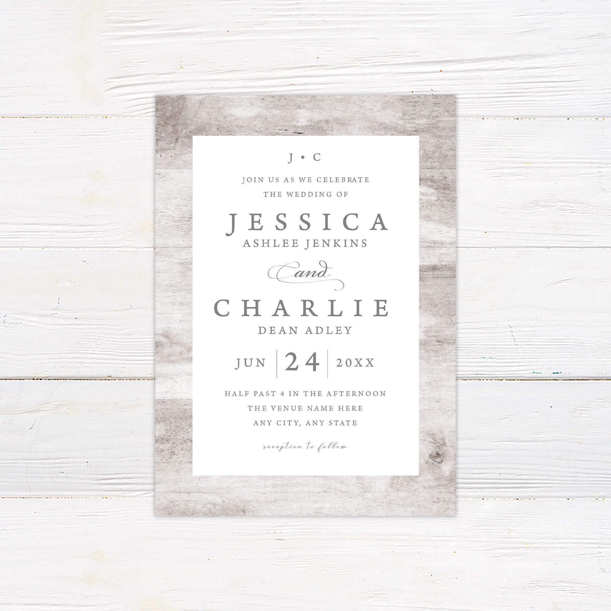 Minimalist rustic wedding invitation with light wood background and elegant serif typography.