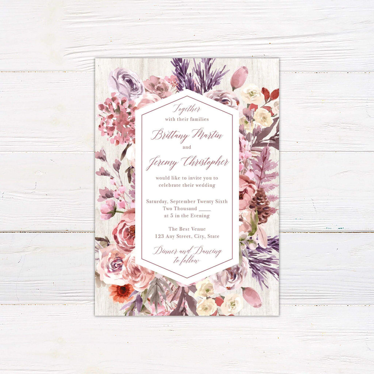 Romantic watercolor wedding invitation with lilac, lavender, and blush floral design and rustic wood background.