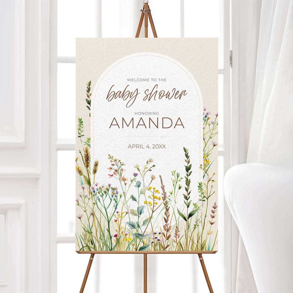 "A vertical welcome sign with a soft, neutral background featuring an elegant arched frame in the center. The text is in a mix of stylish script and serif fonts, warmly greeting guests to the baby shower. The bottom and sides of the design are adorned with delicate watercolor wildflowers in pastel shades of pink, yellow, green, and purple, creating a rustic and nature-inspired aesthetic. The overall look is soft, inviting, and beautifully themed for the event."