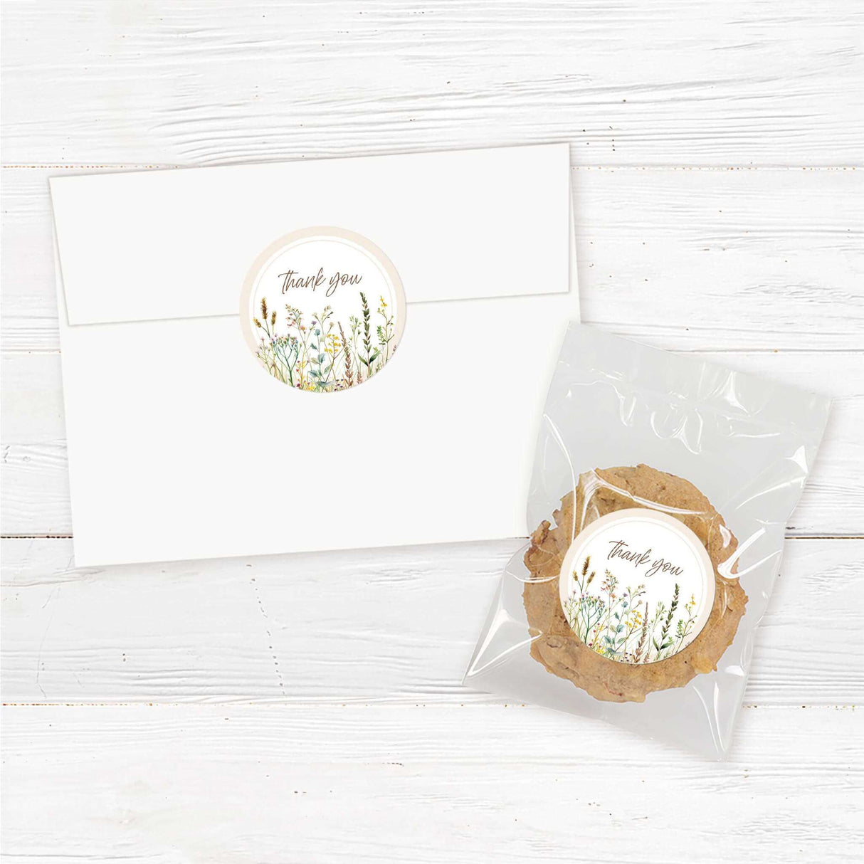 "A set of 2-inch round stickers with a soft, neutral background. The design may feature elegant script or serif text, such as ‘Thank You,’ ‘Diaper Raffle,’ or a baby shower-related message. Decorative elements like delicate florals, watercolor greenery, or whimsical baby-themed illustrations enhance the aesthetic. The stickers are designed to complement a baby shower theme, perfect for sealing envelopes, favor packaging, or adding a personalized touch to gifts."