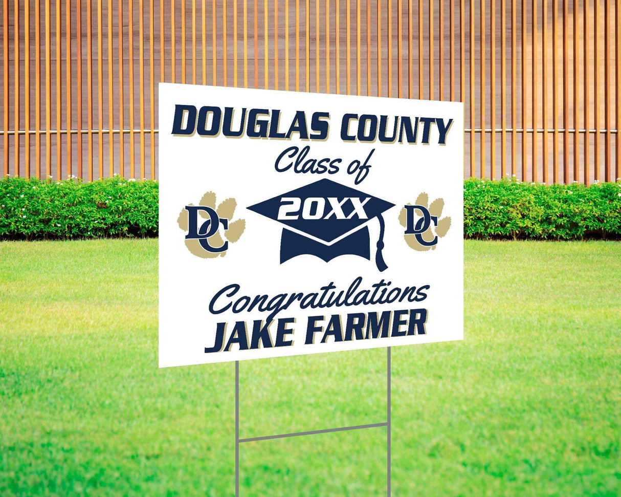 Graduation yard sign with bold text, custom school logo, class year, and congratulatory message. Features a large mortarboard cap graphic and varsity-style font. Printed on durable Coreplast plastic, perfect for outdoor display in front yards, driveways, and school events. Douglas County