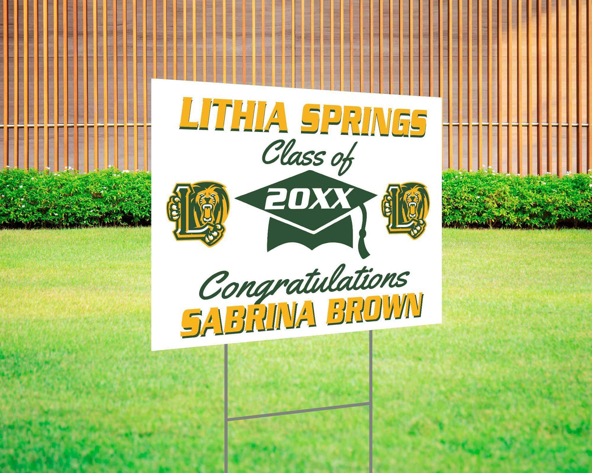 Graduation yard sign with bold text, custom school logo, class year, and congratulatory message. Features a large mortarboard cap graphic and varsity-style font. Printed on durable Coreplast plastic, perfect for outdoor display in front yards, driveways, and school events. Lithia Springs