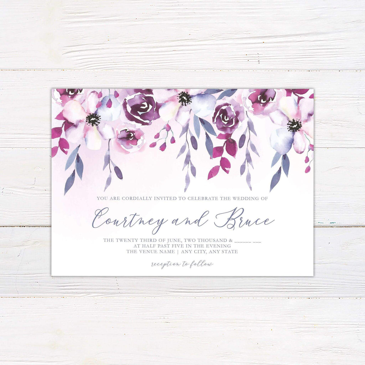 Wedding invitation with watercolor flowers in pink and purple hues, cascading from the top, with elegant script and serif text on a white background