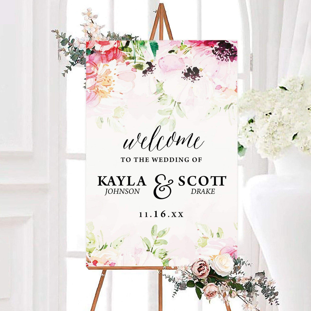 Lovely garden wedding welcome sign featuring pink, blush, coral, and cream watercolor garden flowers with elegant black personalized typography. A romantic floral design created to welcome guests to a wedding ceremony or reception.