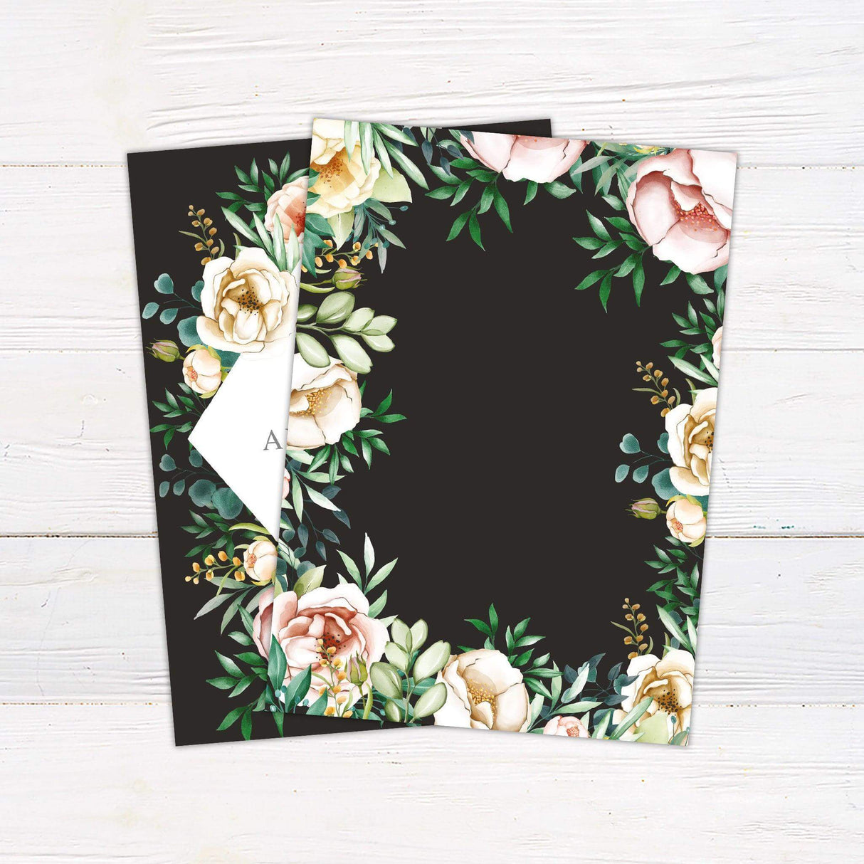 Wedding invitation with lush watercolor florals on a dark background, diamond-shaped white frame, and elegant script and serif text - back